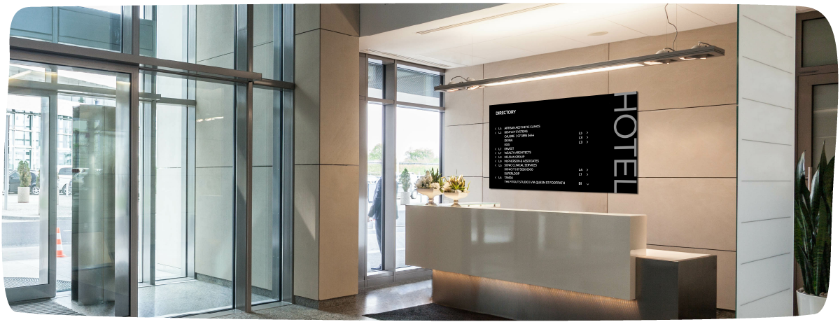 Hotel lobby image with large digital display behind the counter with a directory floor list