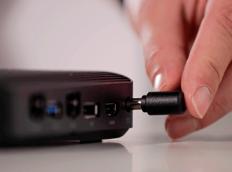 A close up of a Digital Media Player with a plug being inserted into the back.