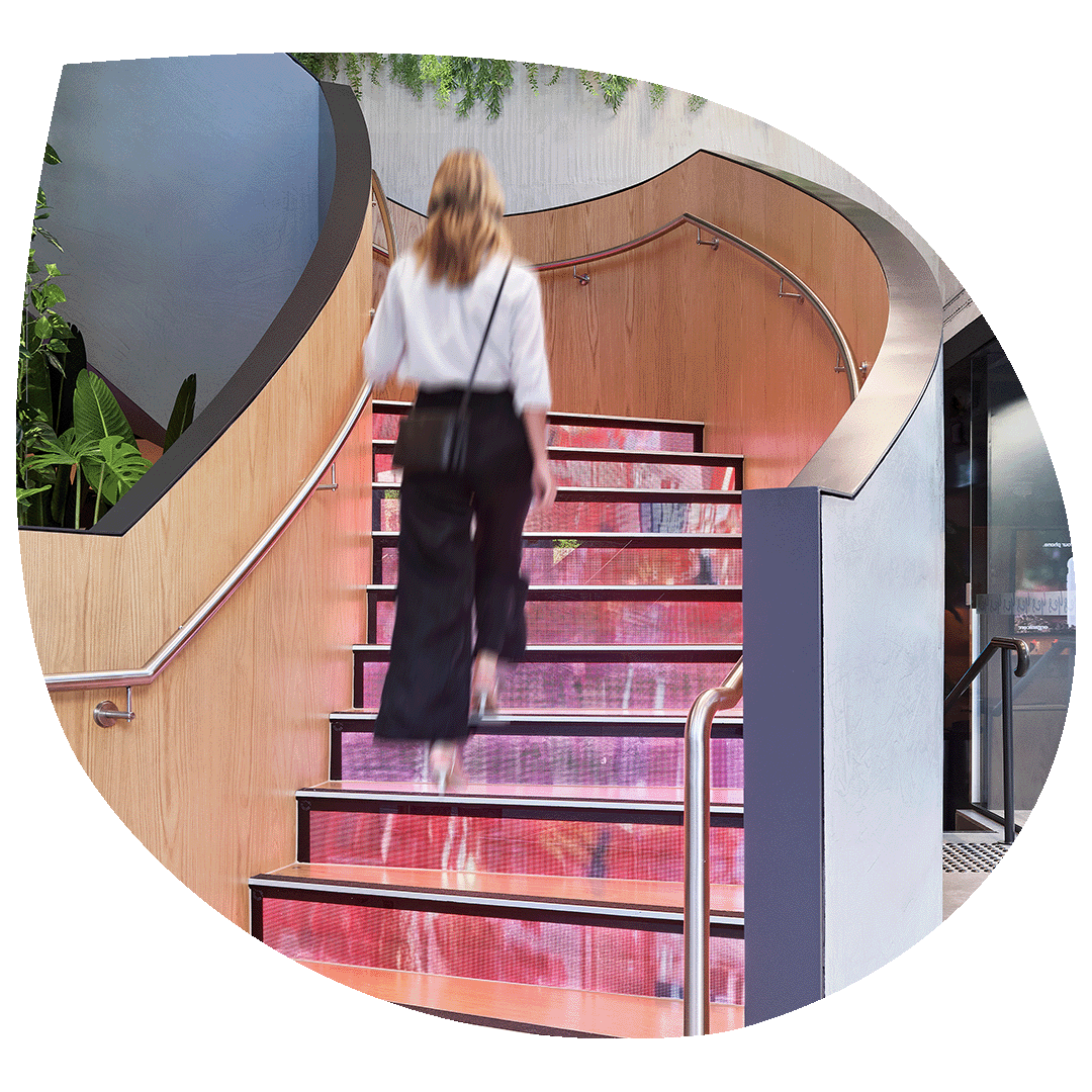 Girl walking up a set of LED tred stairs