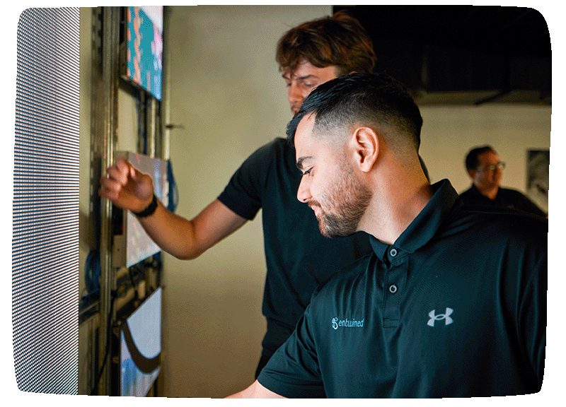 Technicians work on an LED wall