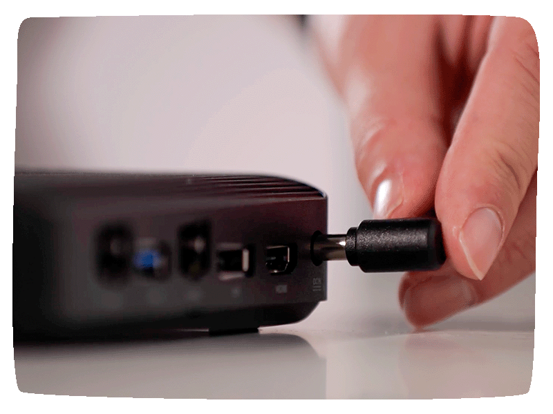 Close of up a digital media player with a hand inserting a cord into it.