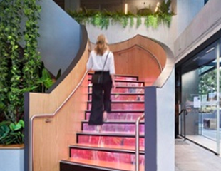 Girl walking up a set of LED tred staircase